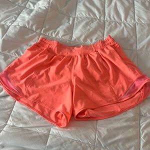 Lululemon hotty hots in a bright coral orange color